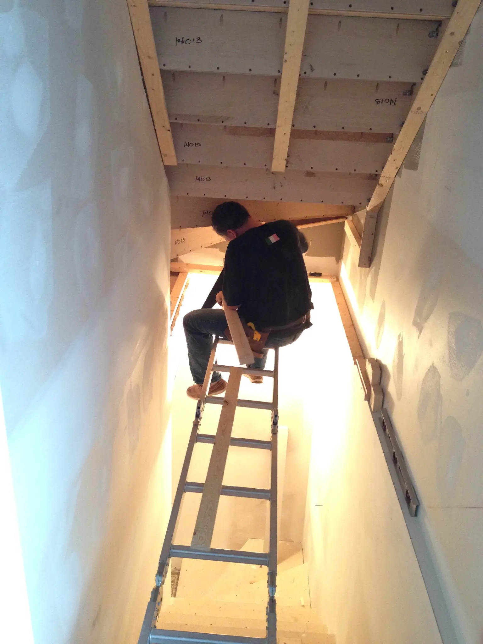 Earle G. Hall building and working with his hands on a construction project