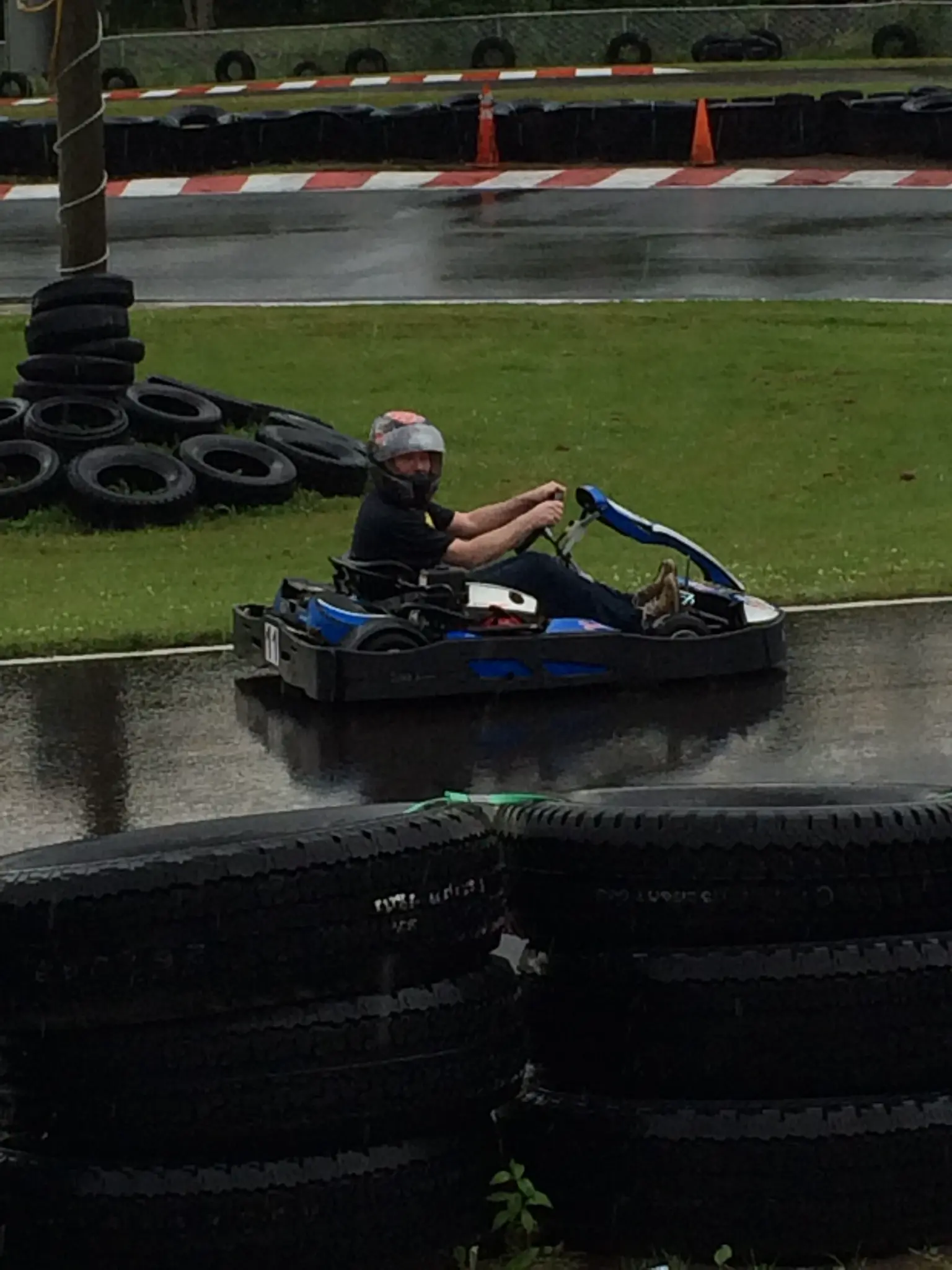 Earle G. Hall racing a go-kart in the rain