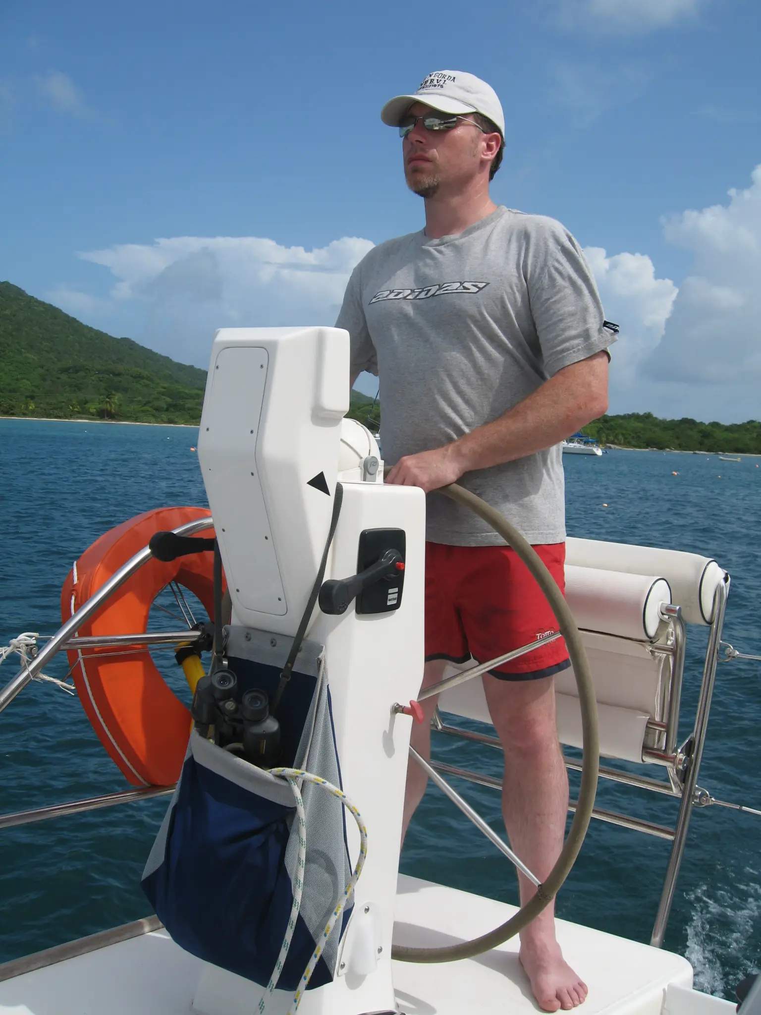 Earle G. Hall at the helm of a sailboat